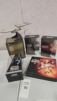 Photo showing Star Wars box sets and Lord of the Rings box set with a Starship Enterprise model on top.