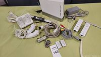 Full view of Wii console, controllers, cables, and accessories on table.