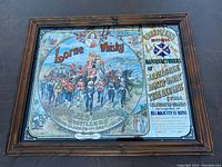 Photo of vintage bar style mirror with Lorne Whiskey branding including soldiers parade graphic and text