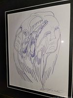 Framed original ink sketch showing multiple abstract human faces with flowing lines.