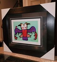 Framed fine art print by David Morrisseau titled Double Headed Thunderbird with visible signatures and edition number.
