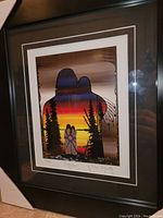 Front angled view of the framed art print showing vivid colors and artist signature.