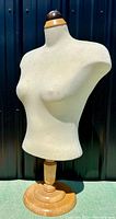 Front view of the female dress form mannequin showing fabric torso and wooden base