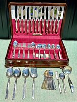 Overall set in tarnish proof wooden chest showing knives, forks, spoons and serving utensils.