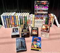 Photo showing the full collection of VHS tapes arranged in rows, including boxed sets and individual movie tapes.