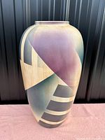 Full view of the John Bergen Studio large floor vase showing the abstract geometric pattern in purple, blue, beige, and gray on a tall ceramic body.