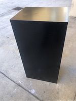 Side view of black metal file cabinet showing smooth surface and compact size.
