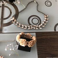 Necklace with clear marquise rhinestones and peach flower bracelet shown