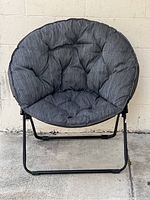 Front view of the folding papasan chair showing the black metal frame and dark gray tufted cushion