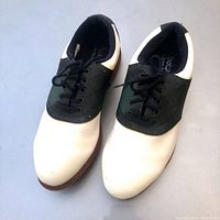 Top view of the white and black Footjoy ladies golf shoes with laces tied