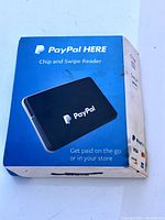 Front of box showing the PayPal Here Chip and Swipe Reader with product image and branding.