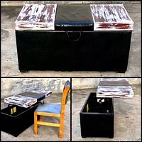 Black storage ottoman with adjustable top including weathered white and brown wood panels and black cushioned center, shown closed against wall.