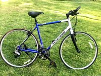 Side view of Schwinn road bike showing blue and silver N'Litened 7000 Series Gold Label aluminum frame, carbon fork, and wheels