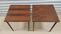 Two rosewood side tables side by side showing square tops and tapered legs