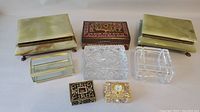 Overview of all seven jewelry boxes showing alabaster, wooden, crystal and ornate clocked boxes.