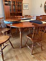Dining table assembled with chairs, leaves and lazy susan on top