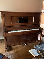 Angled front view of upright piano showing wood finish and overall condition