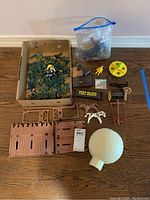 Full lot showing all plastic army men, fort parts, wagon, accessories, and yellow spinning toy.