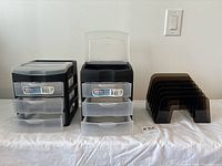 Front view of two Sterilite three drawer units and vintage W.T. Rogers desk organizer on white cloth covered surface.