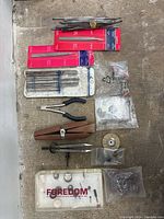 Top down overview of jewelry making tools including files, mandrels, tweezers, carving tools and Foredom accessory case.