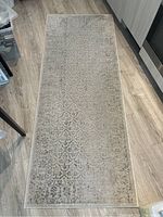 Full top view of the beige patterned runner rug showing overall design and size relative to floor