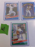 Three baseball cards placed side by side: Bo Jackson batting card, Barry Bonds Diamond Kings card, Nolan Ryan pitching card with '300th Win'