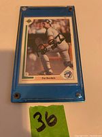 Front view of Pat Borders baseball card in blue plastic case, showing full card image and autograph