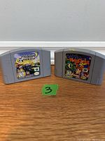 Front view of Penny Racer and Banjo-Kazooie Nintendo 64 cartridges showing game label artwork and condition