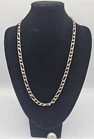 Front view of the Italian 925 sterling silver Figaro chain necklace displayed on a black bust.