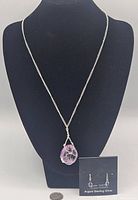 Sterling silver chain necklace with amethyst quartz pendant displayed on a black mannequin bust.