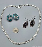 Full view of sterling silver chain necklace, blue enamel earrings, and onyx sterling earrings with quarter for size reference