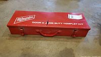 Red metal Milwaukee carrying case for Door and Jamb Butt Templet Kit with logo and label