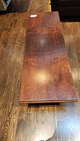 Top view of solid maple coffee table showing wood grain and surface wear