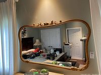 Front view showing full mirror and carved frame