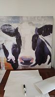 Full front view of the canvas showing the cow's face artwork with black, white, and gray tones.