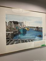 Framed watercolour painting of fishing boats along dock in East Berlin, Nova Scotia. Shows entire artwork and frame.