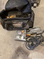 Overall view of the Rockwell Versacut skill saw, extra blade inside carry bag, and carry bag open showing contents.