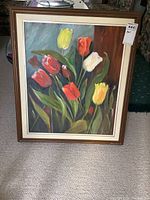 Full view of the framed acrylic painting showing tulips in multiple colors with signature on bottom right corner.