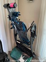 Backmate inversion table folded for storage with visible padded ankle holders and frame structure.