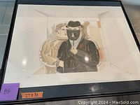 Framed cartoon art piece showing two figures, one with a mask and hat, the other in beige dress. Visible signature on bottom right corner.