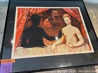 Framed print depicting two figures at a table with red curtains, measuring 27 x 31 inches