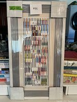 Front view of framed print wrapped in protective film with measurement sticker visible