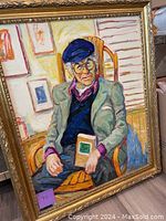 Frontal image of the oil painting of an elderly man seated in a wooden chair holding a book, showing the full image and ornate frame.
