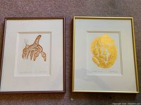 Two framed prints side by side showing detailed Haida art images by Bill Reid titled 'Haida Killer Whale' and 'The Bear Mother'.