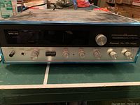 Front view of Sansui Model 2000 amplifier showing faceplate, controls, and model labeling