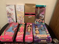Full view of eight boxed Barbie dolls including Spring Blossom, Spring Petals, Avon Winter Rhapsody, 90210 Brandon, Sparkle Beach Kira, Pocahontas Nakoma, Cool Blue, and Ruffle Fun.