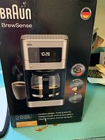 Box front showing Braun BrewSense KF 7370 coffee maker image and features, including 12-cup capacity, fast brew cycle, BrewChrono timer, and 2 year warranty.