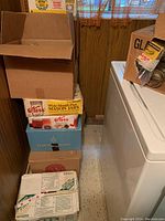 Stack of sealed boxes containing canning jars including 'Kerr Wide Mouth Pint Mason Jars' and others with old brand labels.