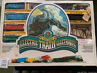 Full boxed set showing Bachmann HO scale electric train with multiple freight cars and track inside sealed box.
