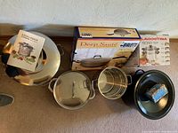 Overhead view of all cookware items including canner, strainer, sauté pans, boxed Bialetti and Lagostina